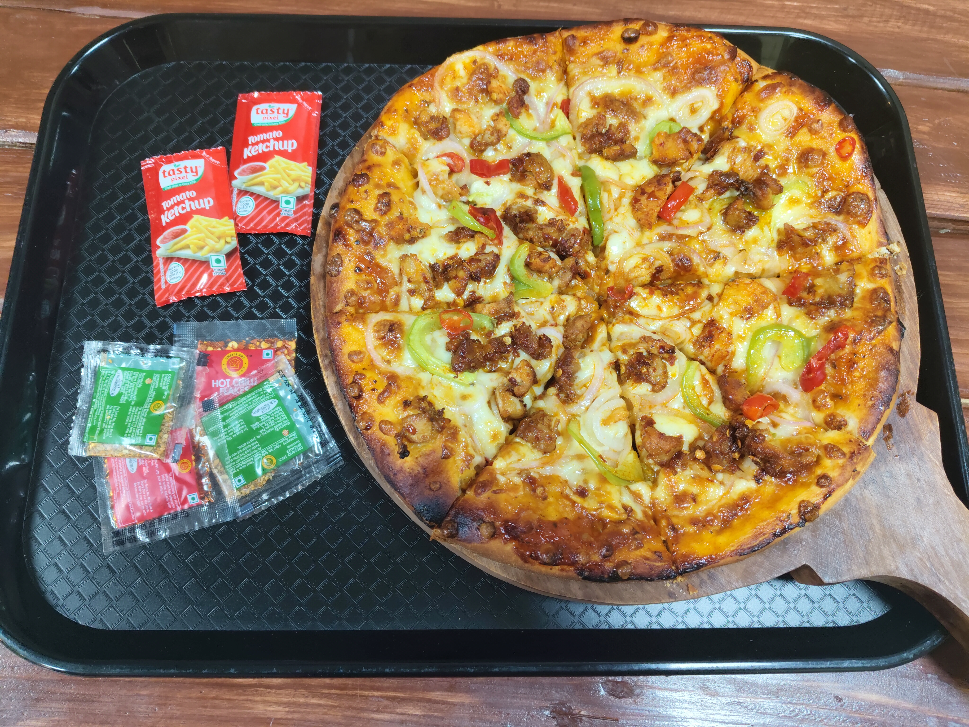 Freshly baked loaded pizza served at Tempting Cakez & Cafe Surapet